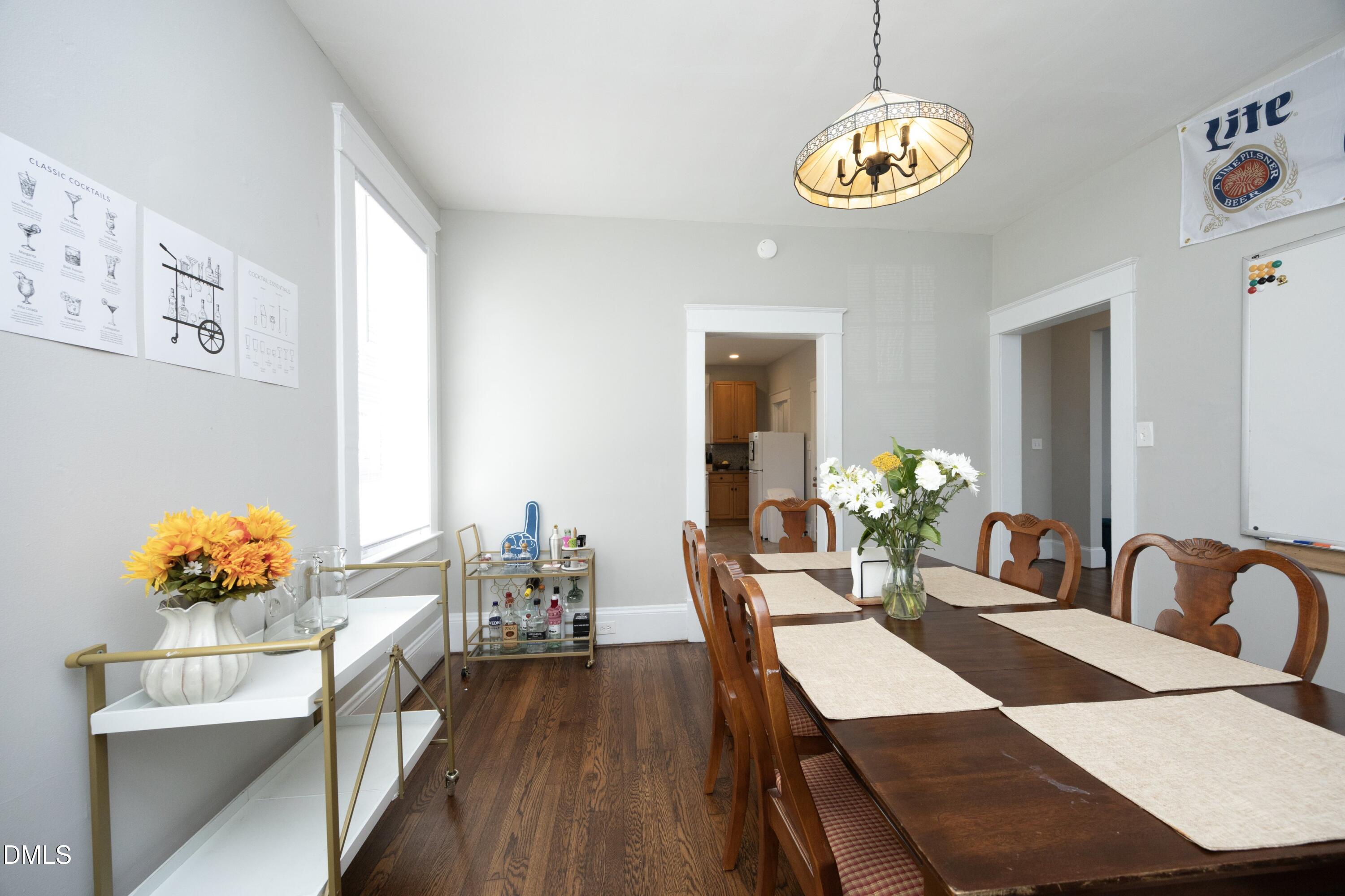 206 Ashe Avenue Raleigh, NC 27605 - Photo 14 of 37 a view of a dining room with furniture and chandelier