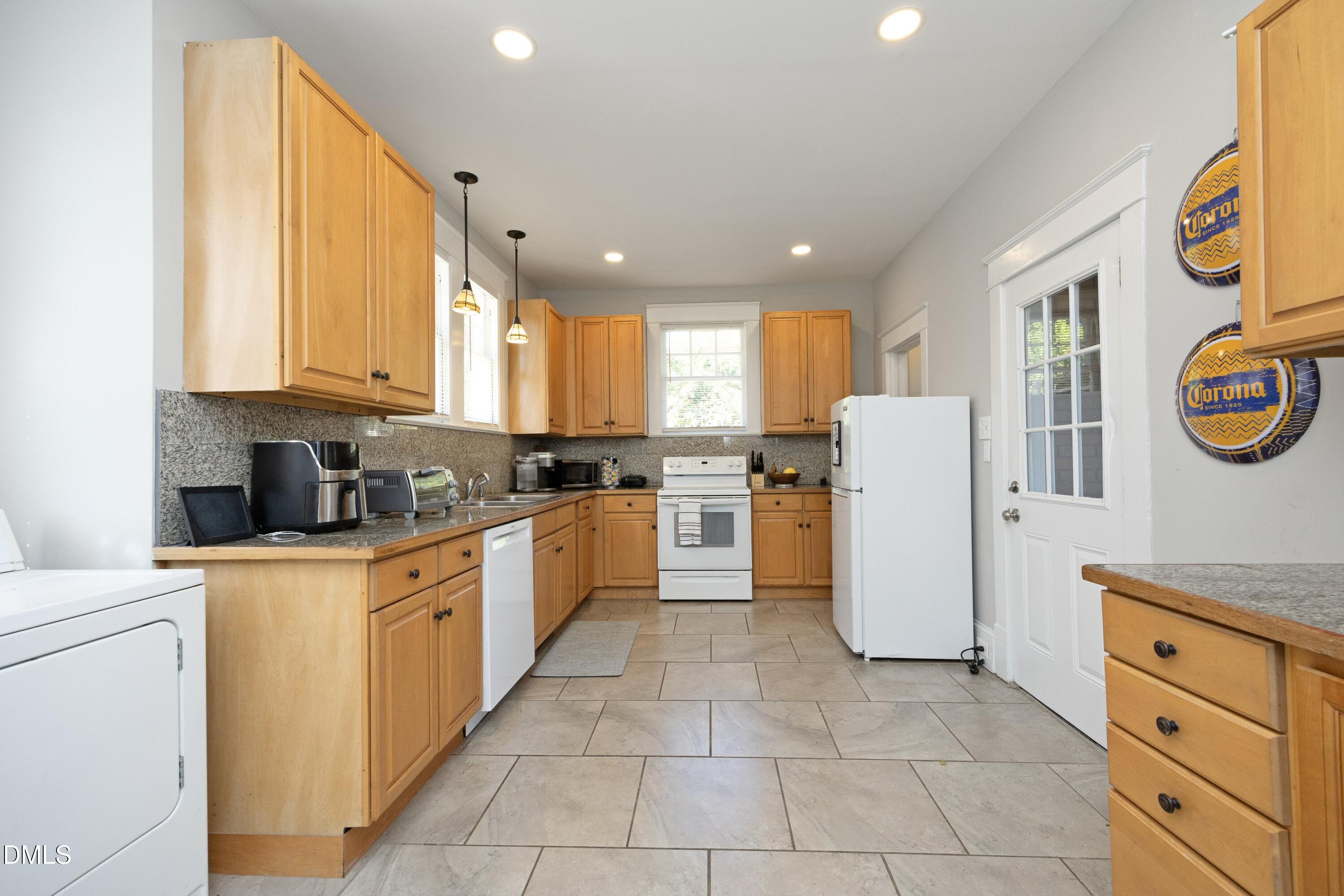 206 Ashe Avenue Raleigh, NC 27605 - Photo 15 of 37 a kitchen with cabinets and a window
