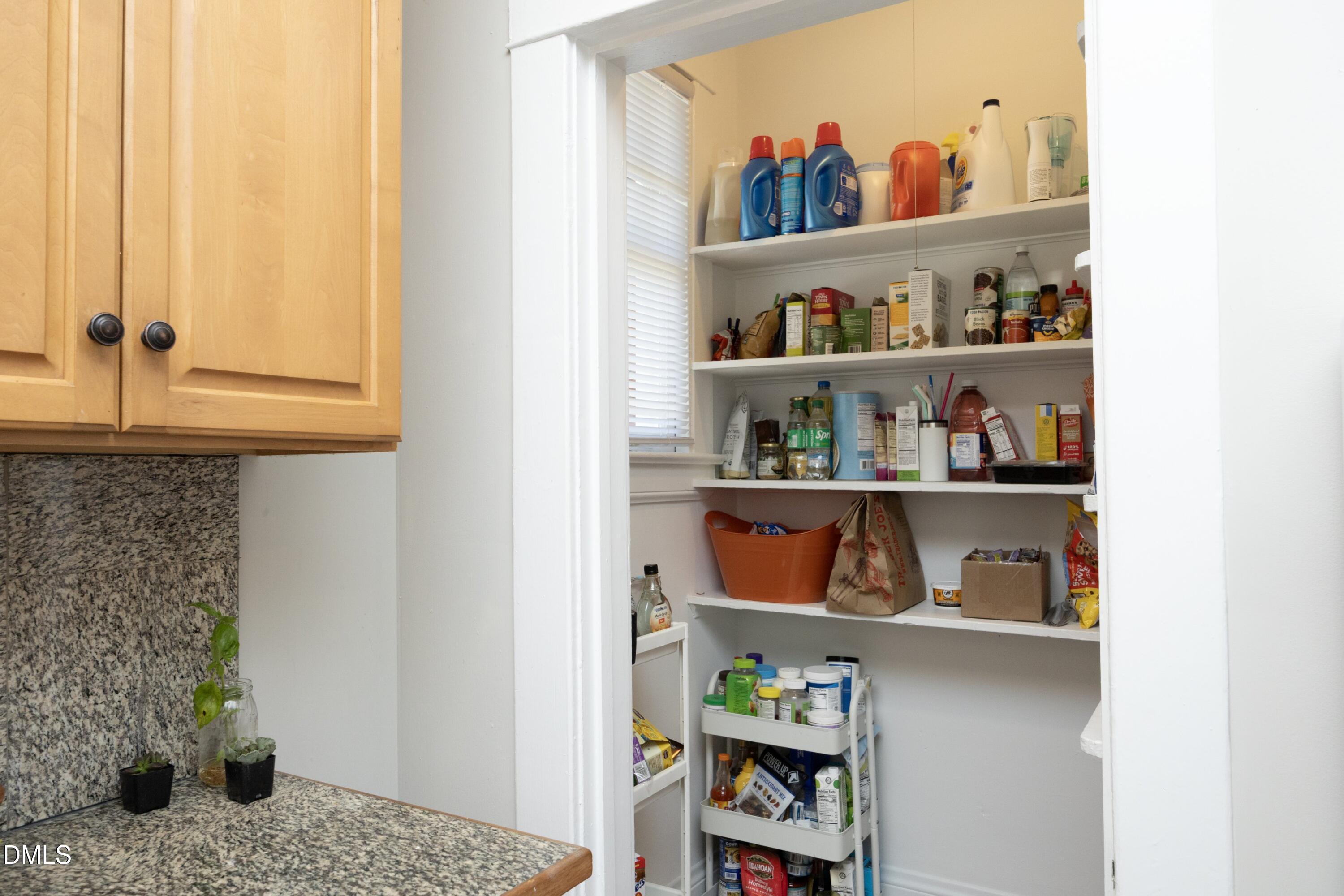 206 Ashe Avenue Raleigh, NC 27605 - Photo 19 of 37 a cabinet with food on it and a painting on the wall