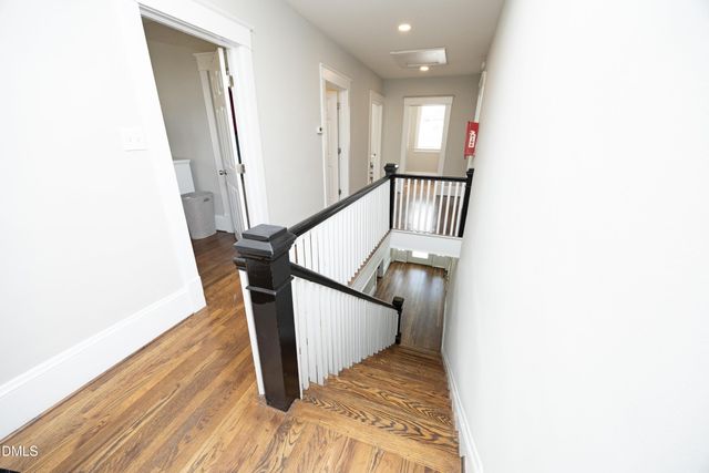 a view of a hallway with wooden floor