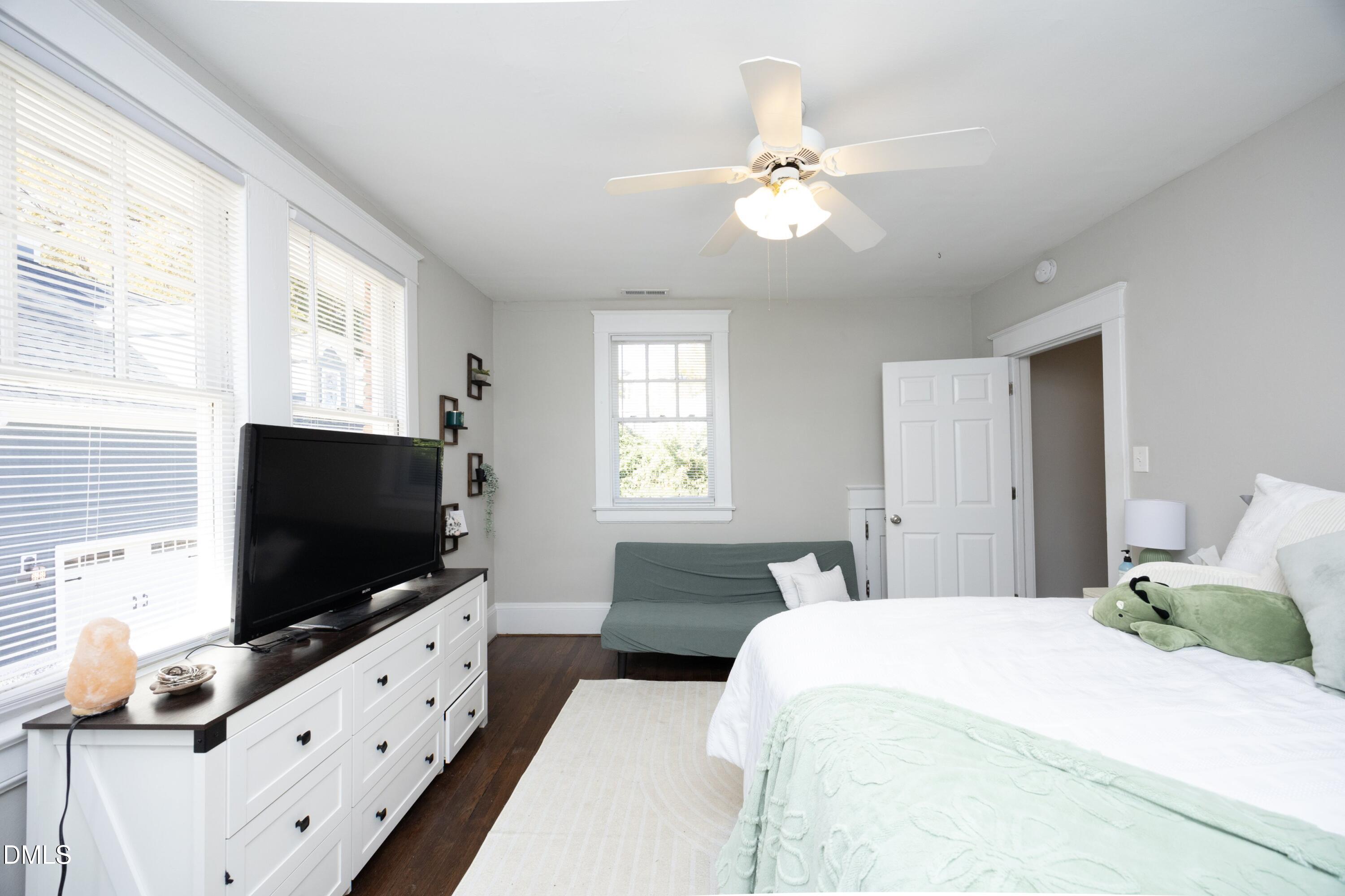 206 Ashe Avenue Raleigh, NC 27605 - Photo 28 of 37 a bedroom with a bed and a flat screen tv