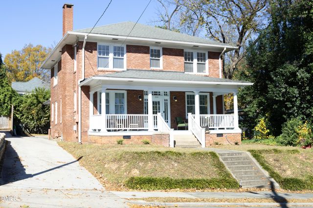 a front view of a house with a yard outdoor seating