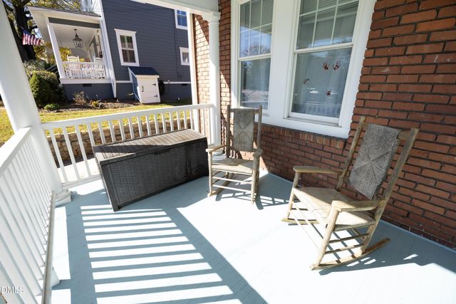 a balcony with table and chairs