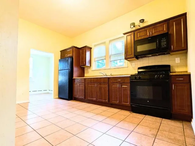a kitchen with stainless steel appliances a stove and a microwave