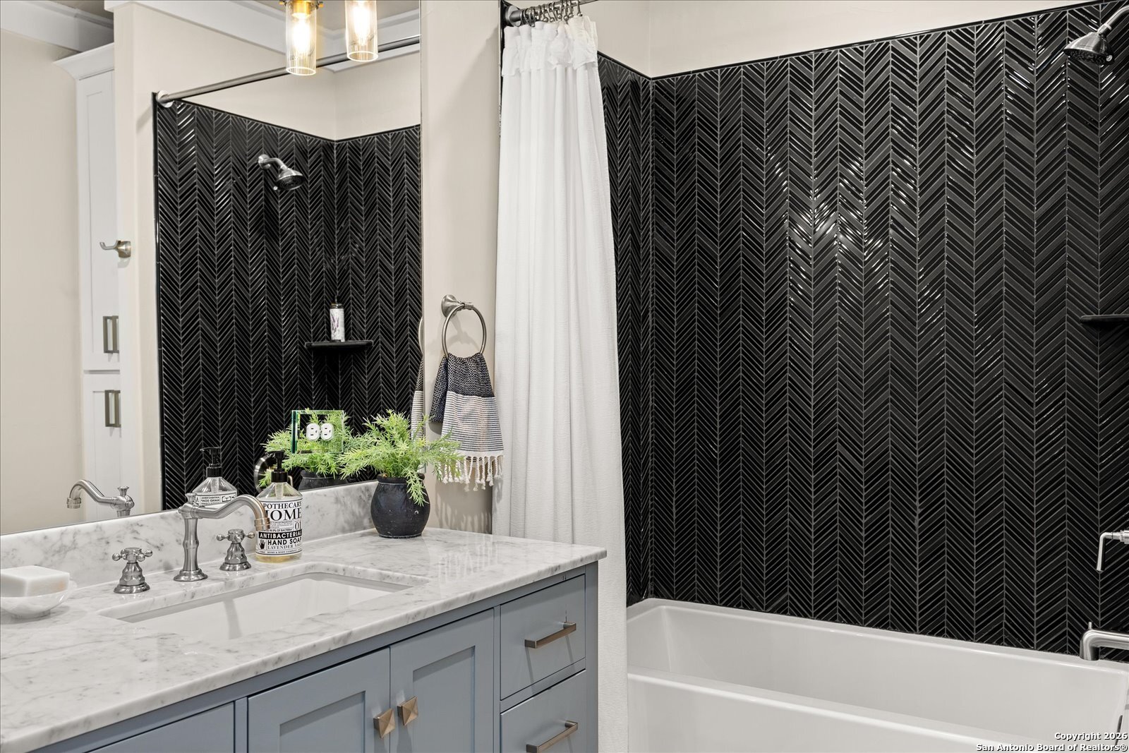 1006 High Street Comfort, TX 78013 - Photo 32 of 50 a bathroom with a granite countertop sink and a mirror