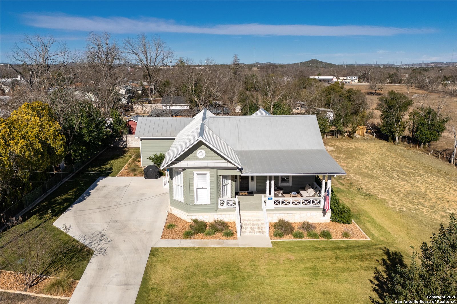 1006 High Street Comfort, TX 78013 - Photo 4 of 50 a house with trees in the background