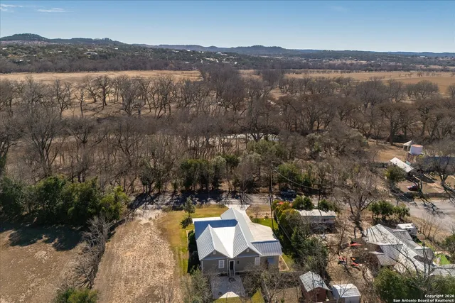 an aerial view of a house with a yard