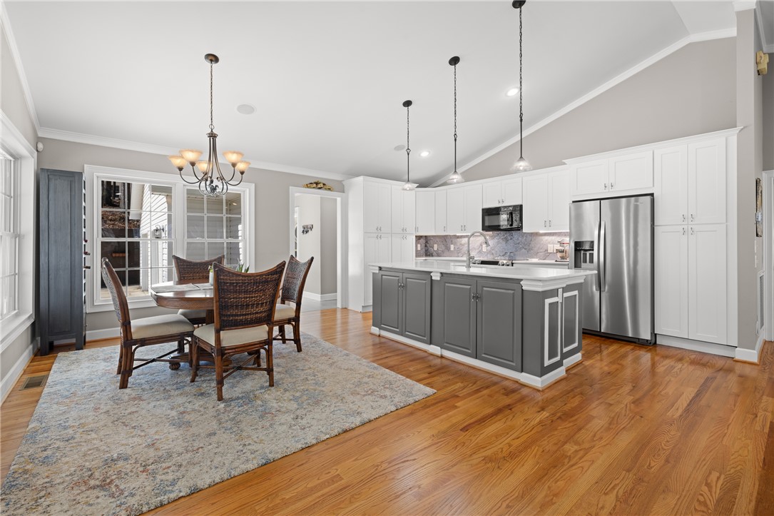 204 Riverlake Road Fair Play, SC 29643 - Photo 8 of 50 This bright kitchen and dining area features vaulted ceilings, hardwood flooring, and a spacious kitchen island.