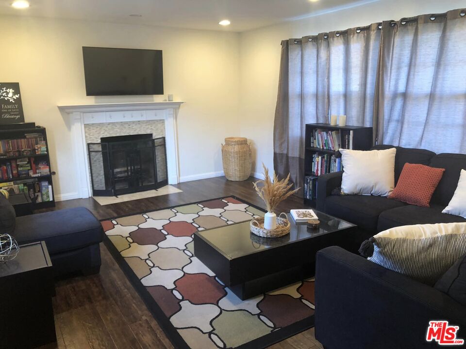 549 East Collamer Drive Carson, CA 90746 - Photo 3 of 10 a living room with furniture fireplace and flat screen tv
