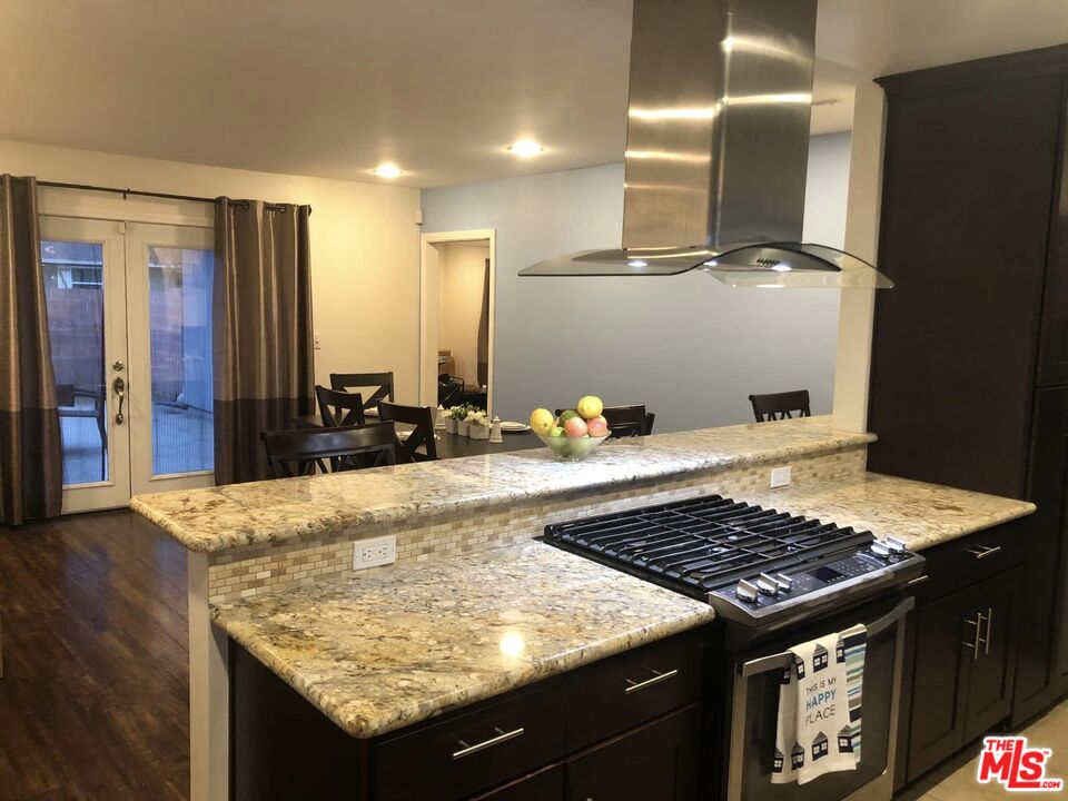 549 East Collamer Drive Carson, CA 90746 - Photo 5 of 10 a kitchen with a stove and a wooden floor