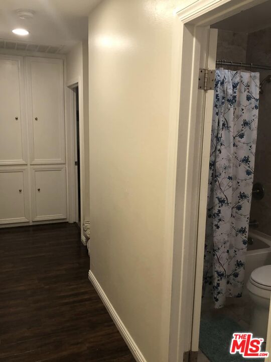 549 East Collamer Drive Carson, CA 90746 - Photo 6 of 10 a view of a hallway with wooden floor and a bathroom