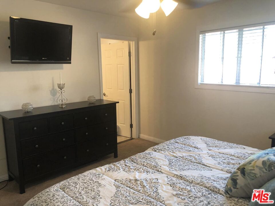 549 East Collamer Drive Carson, CA 90746 - Photo 8 of 10 a bedroom with a bed and a flat screen tv