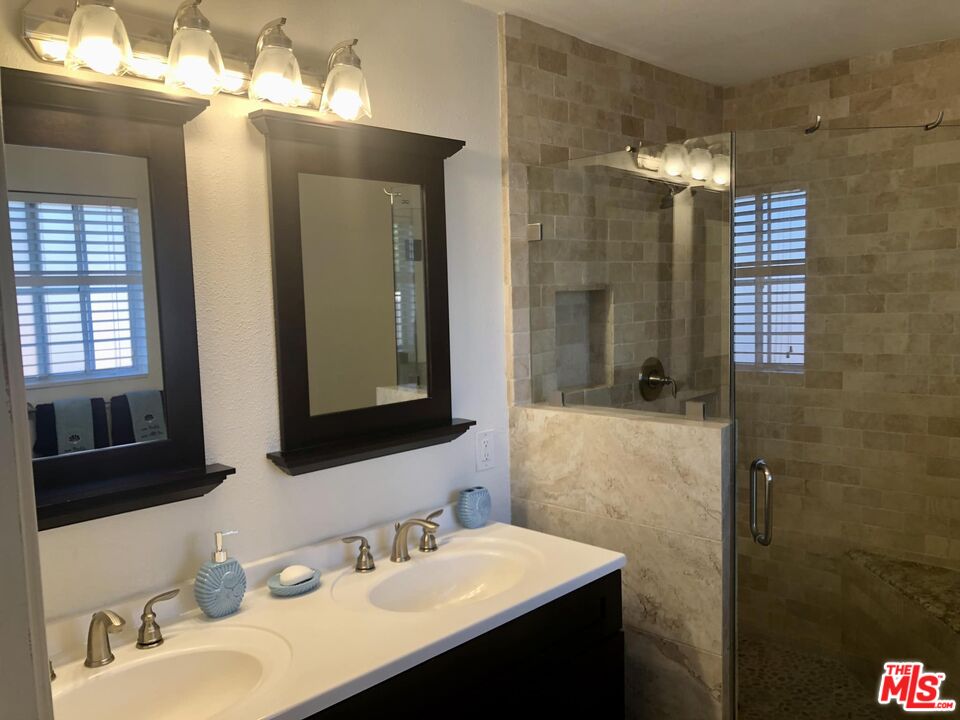 549 East Collamer Drive Carson, CA 90746 - Photo 9 of 10 a bathroom with a double vanity sink mirror and shower