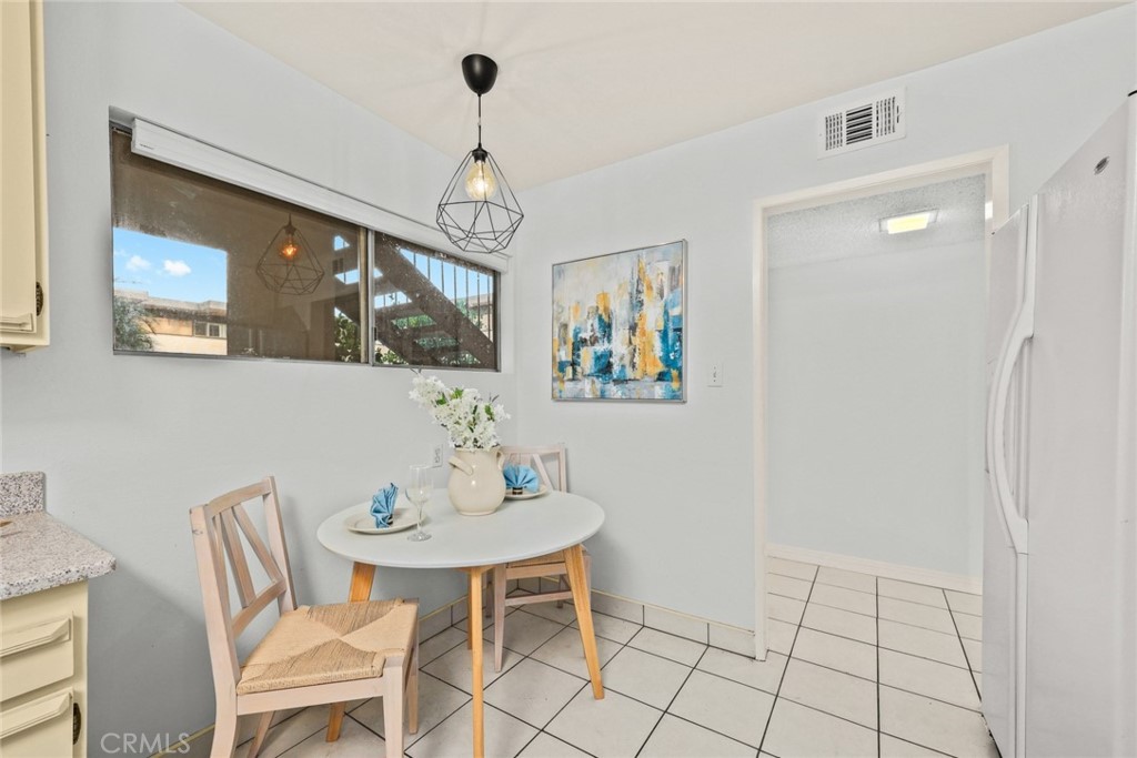 540 Fairview Avenue, Unit 27 Arcadia, CA 91007 - Photo 17 of 40 a view of a dining room with furniture a chandelier and wooden floor