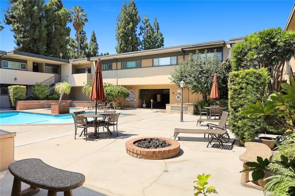540 Fairview Avenue, Unit 27 Arcadia, CA 91007 - Photo 32 of 40 a view of a patio with table and chairs potted plants and a large tree