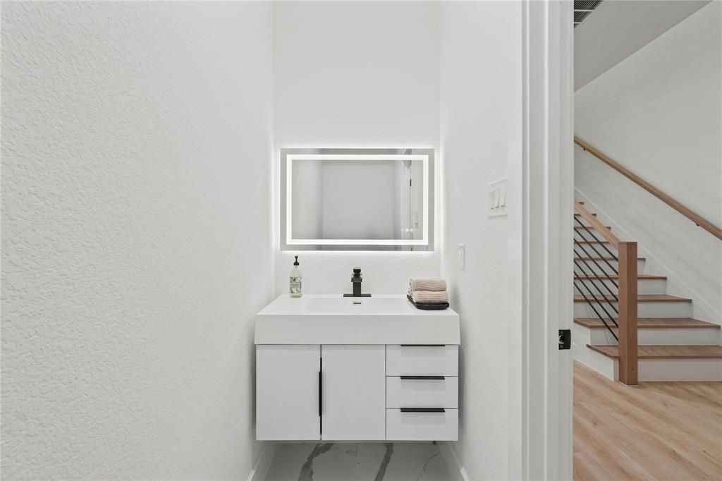 923 Walkway Street Dallas, TX 75212 - Photo 13 of 33 Bathroom featuring vanity and light marble finish flooring