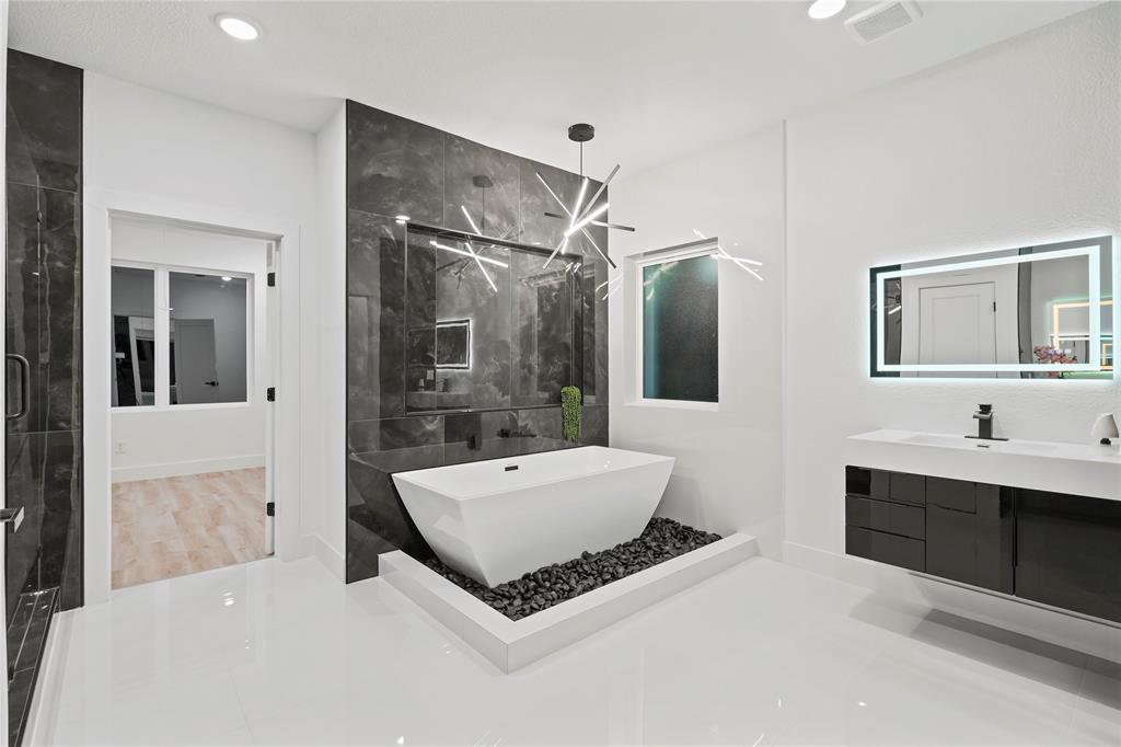 923 Walkway Street Dallas, TX 75212 - Photo 26 of 33 Full bath with a marble finish shower, a freestanding bath, recessed lighting, and vanity