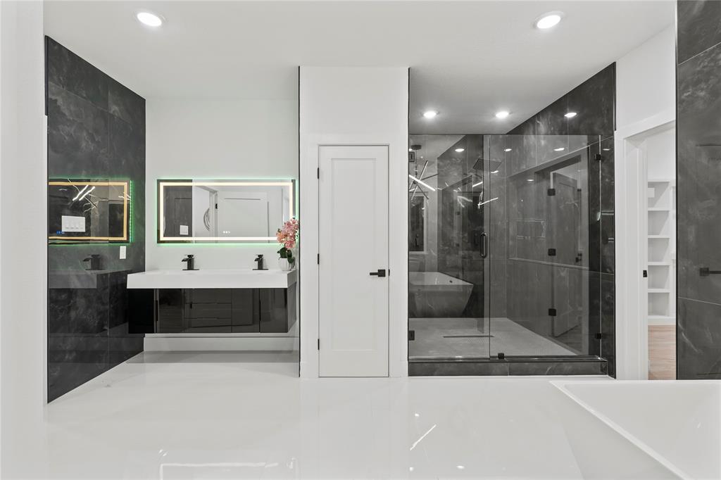 923 Walkway Street Dallas, TX 75212 - Photo 27 of 33 Full bathroom featuring double vanity, a freestanding bath, a marble finish shower, and a spacious closet