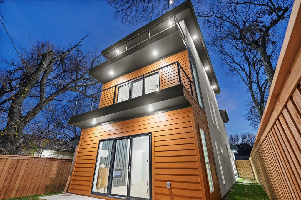 923 Walkway Street Dallas, TX 75212 - Photo 33 of 33 Back of house at twilight with a balcony and a patio