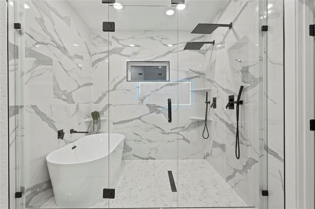 923 Walkway Street Dallas, TX 75212 - Photo 10 of 33 Bathroom with a marble finish shower and a freestanding bath