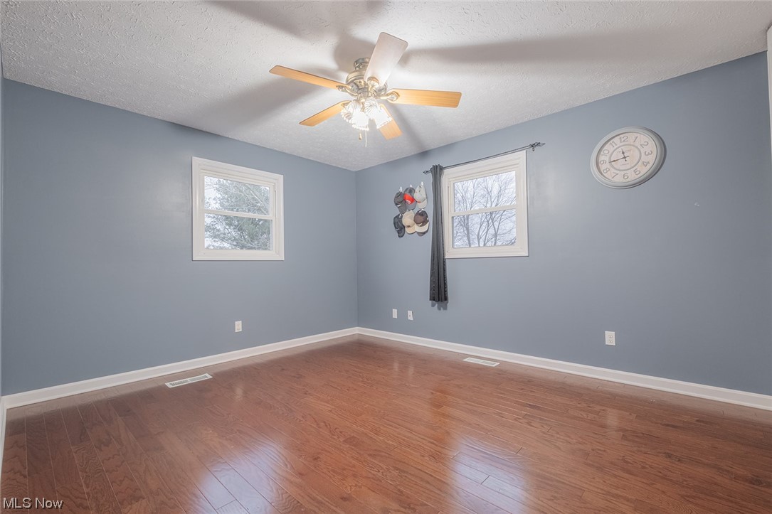 4179 Blake Road Seville, OH 44273 - Photo 12 of 29 Master bedroom with ceiling fan and engineered hardwood flooring.