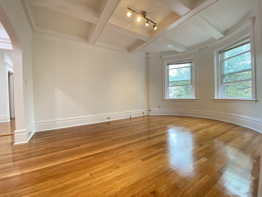 96 Naples Road, Unit 3 Brookline, MA 02446 - Photo 1 of 12 an empty room with wooden floor and windows