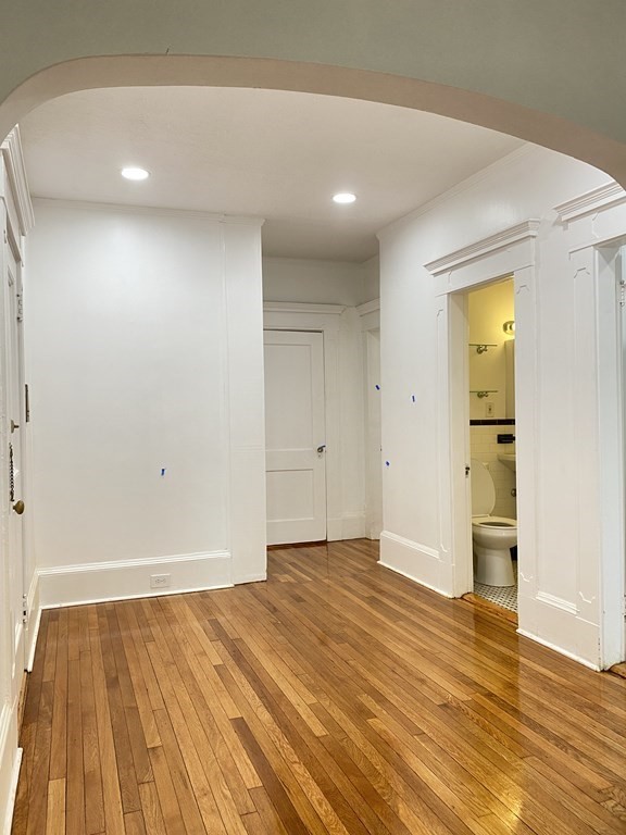 96 Naples Road, Unit 3 Brookline, MA 02446 - Photo 7 of 12 a view of an empty room and wooden floor