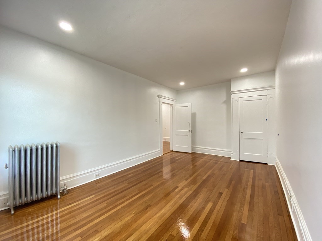 96 Naples Road, Unit 3 Brookline, MA 02446 - Photo 8 of 12 a view of an empty room with wooden floor