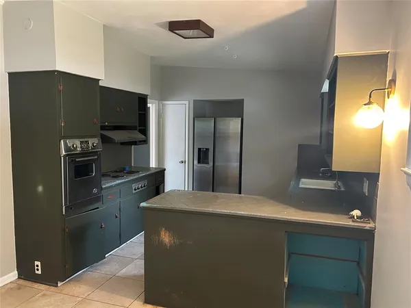 a kitchen with stainless steel appliances a refrigerator and a stove