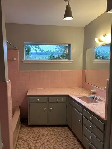 a room with a sink cabinets and utility
