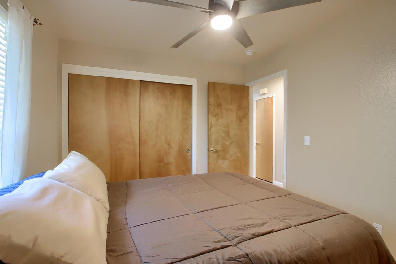 36555 Mudge Ranch Road Coarsegold, CA 93614 - Photo 24 of 80 a bedroom with a bed and a chandelier