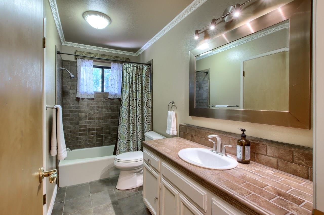 36555 Mudge Ranch Road Coarsegold, CA 93614 - Photo 25 of 80 a bathroom with a granite countertop sink toilet and shower