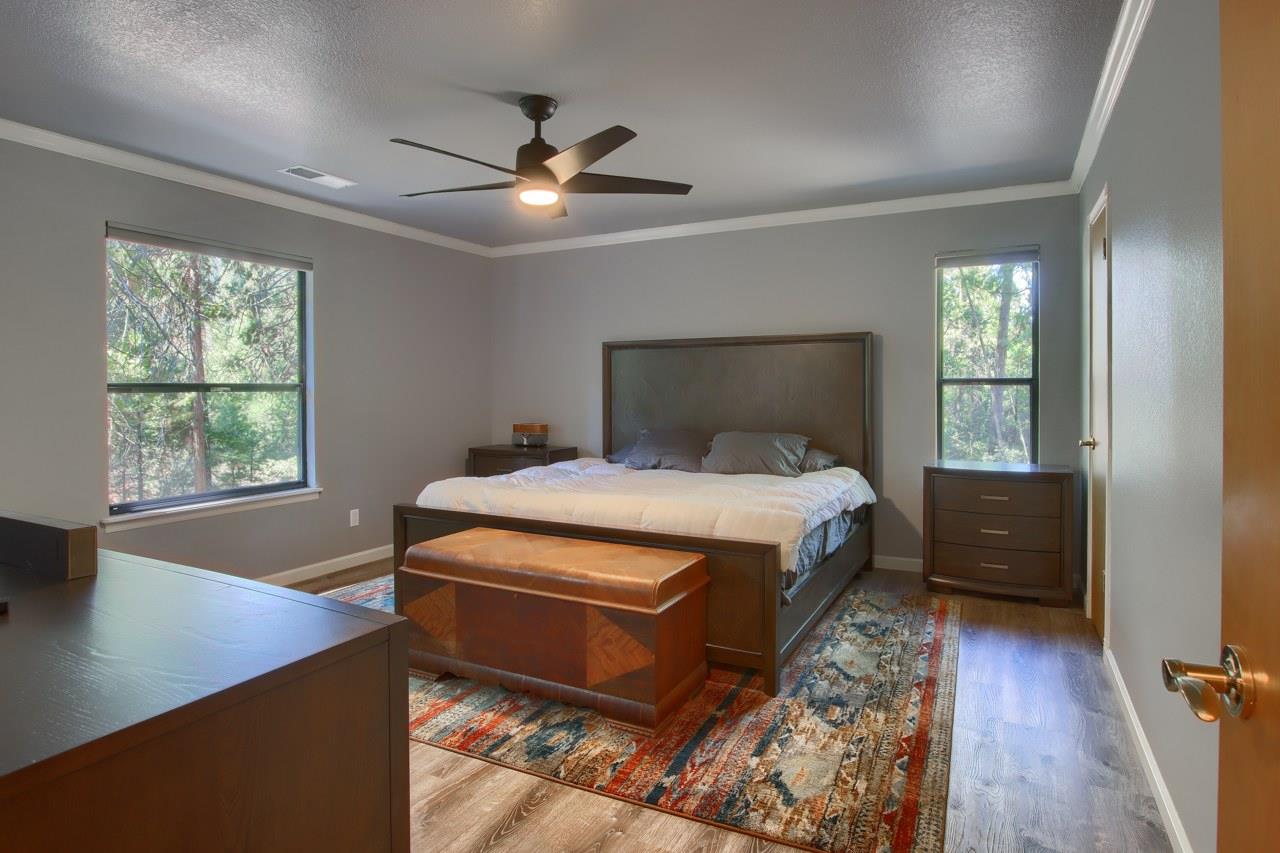 36555 Mudge Ranch Road Coarsegold, CA 93614 - Photo 29 of 80 a bed sitting in a spacious bedroom next to a window