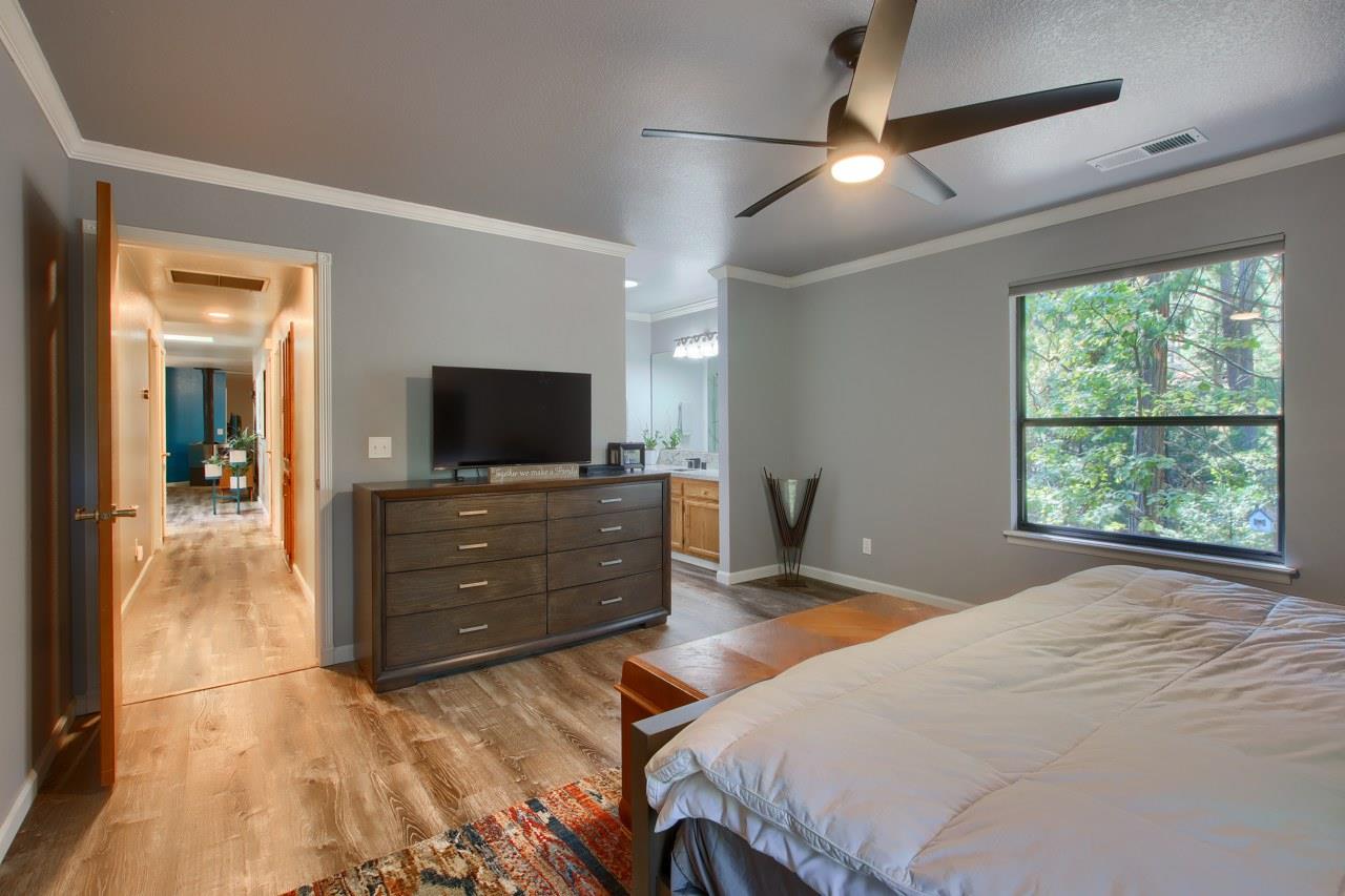 36555 Mudge Ranch Road Coarsegold, CA 93614 - Photo 30 of 80 a bedroom with a bed and a flat screen tv