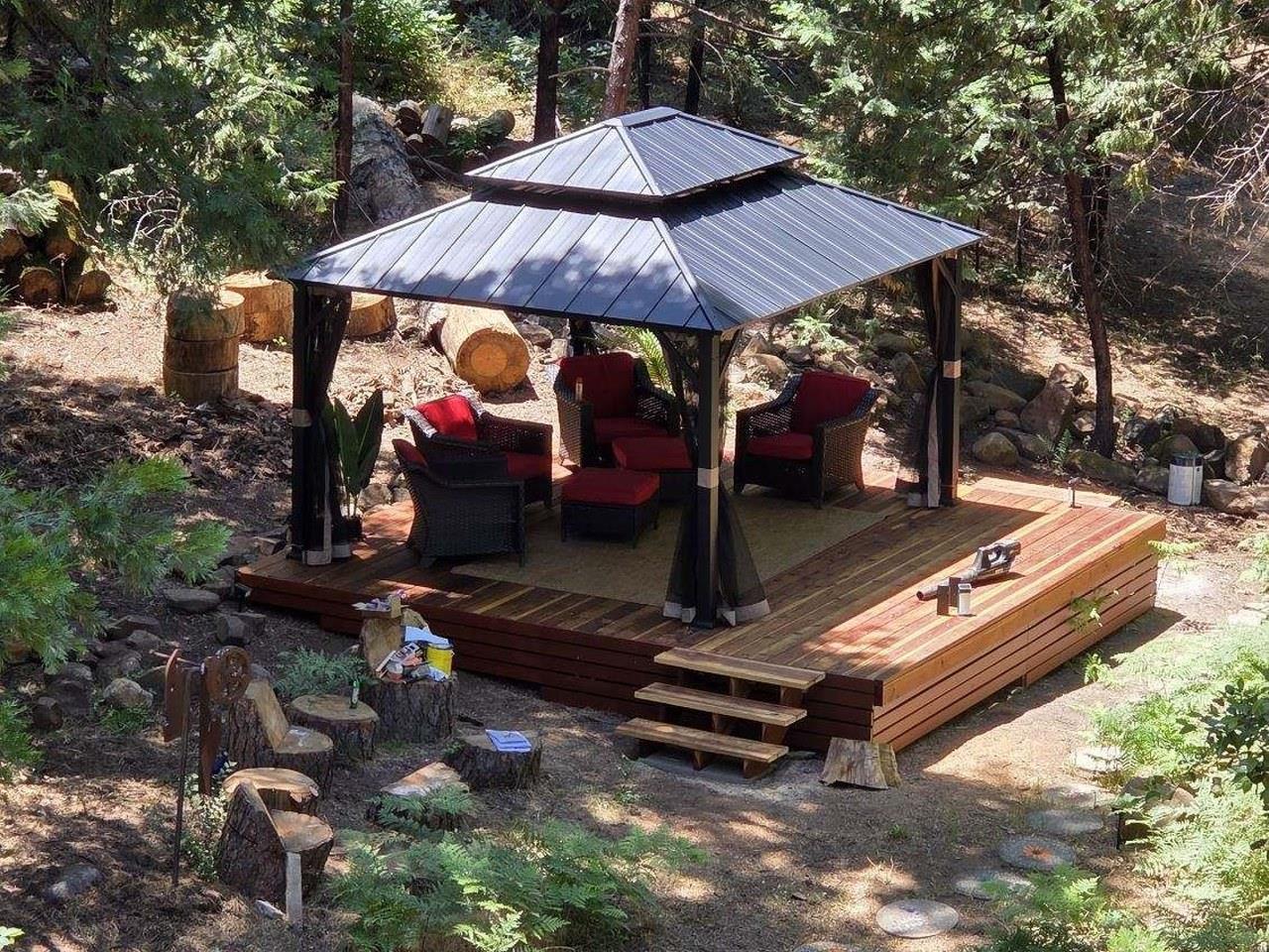 36555 Mudge Ranch Road Coarsegold, CA 93614 - Photo 4 of 80 a view of a sitting area with chairs and umbrella