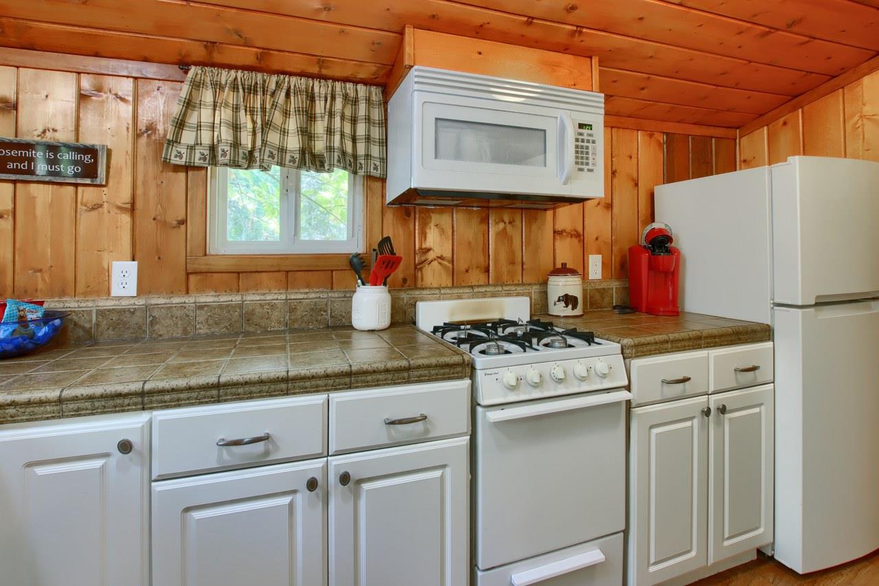 36555 Mudge Ranch Road Coarsegold, CA 93614 - Photo 48 of 80 a kitchen with stainless steel appliances granite countertop a stove a sink and a microwave