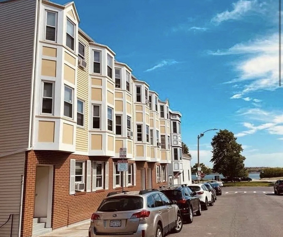 206 H Street, Unit 3 Boston, MA 02127 - Photo 1 of 8 a front view of a building with lot of cars and trees