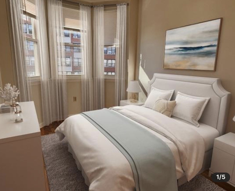 206 H Street, Unit 3 Boston, MA 02127 - Photo 5 of 8 a bedroom with a bed and a painting on the wall
