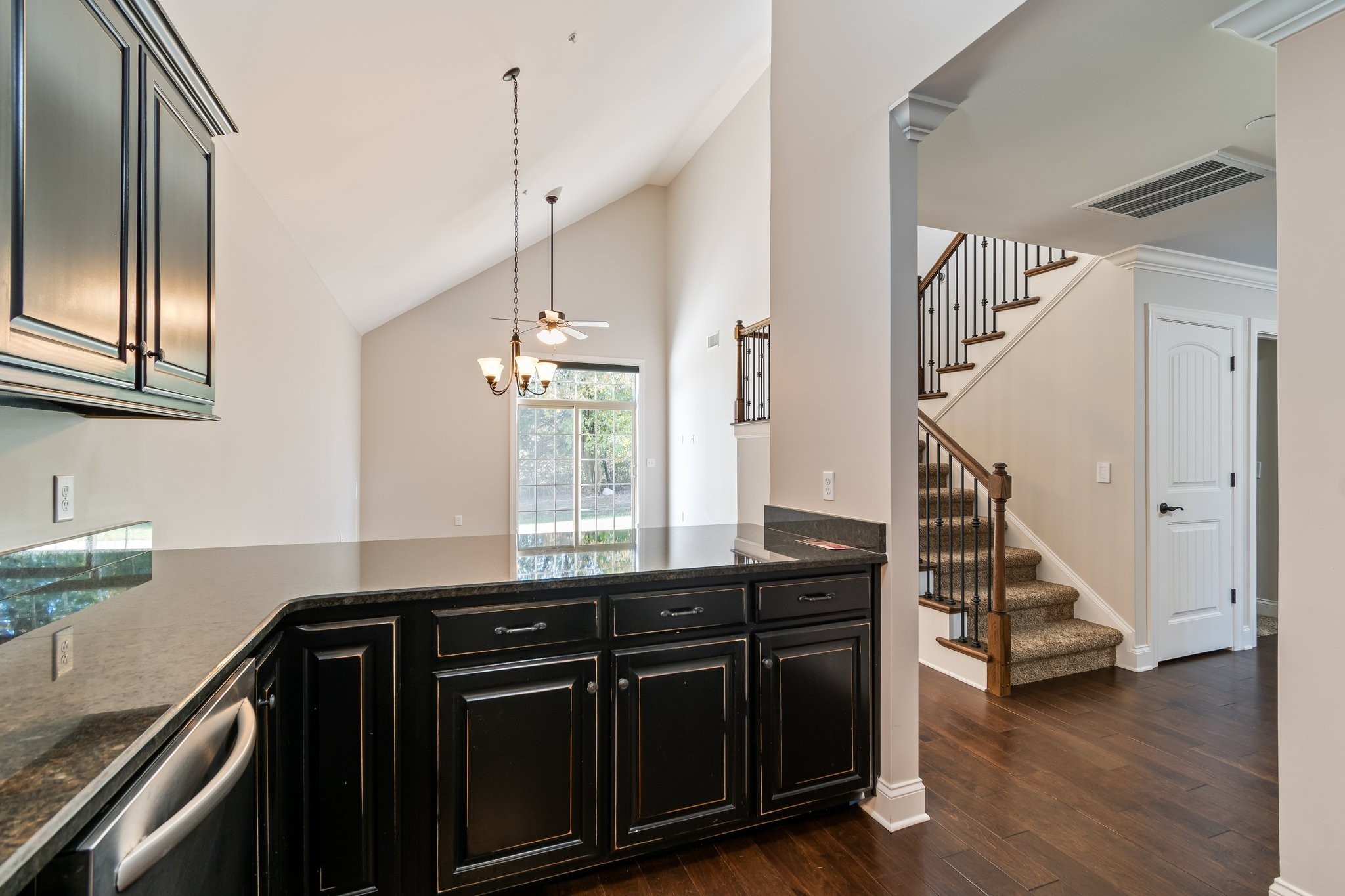 1041 Irish Way Spring Hill, TN 37174 - Photo 12 of 38 a kitchen with granite countertop a refrigerator a stove and wooden floor