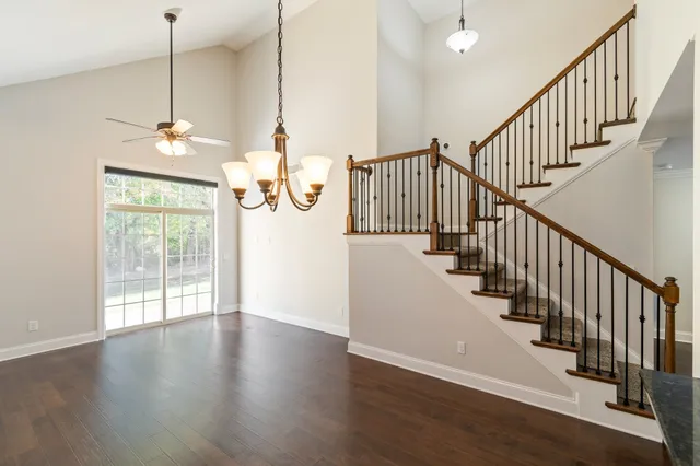a view of a room with wooden floor windows and a chandelier