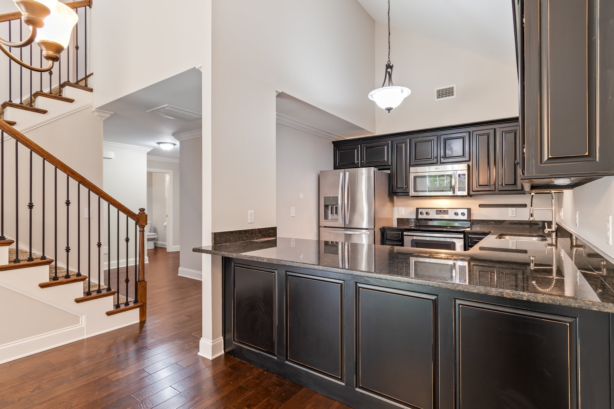1041 Irish Way Spring Hill, TN 37174 - Photo 6 of 38 a kitchen with stainless steel appliances granite countertop a refrigerator a sink dishwasher a stove and a microwave oven on the wooden floor