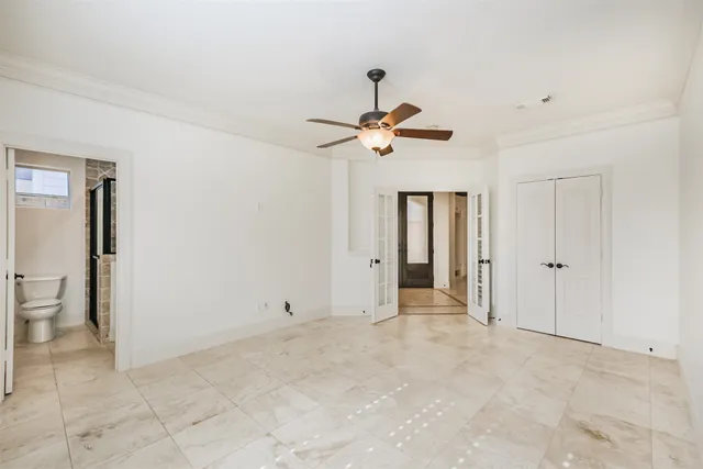 a bathroom with a granite countertop sink mirror vanity and toilet
