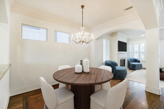 a view of a hallway with wooden floor and a chandelier