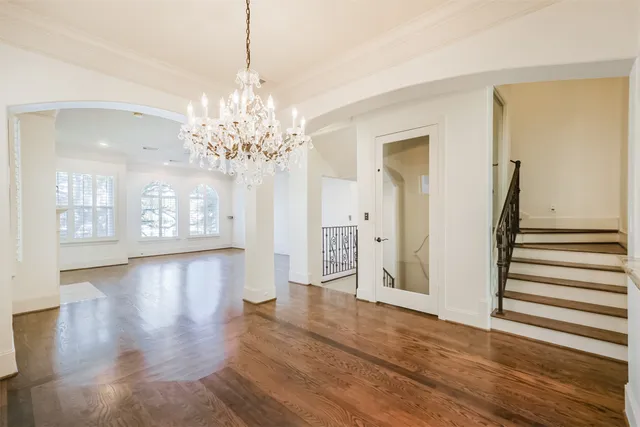 a view of a big room with chandelier and windows