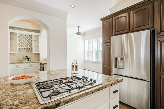 a kitchen with granite countertop a stove window and cabinets