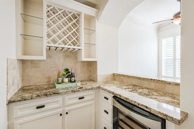 a view of empty room with window and wooden floor