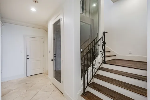 a view of a hallway with wooden floor and entryway