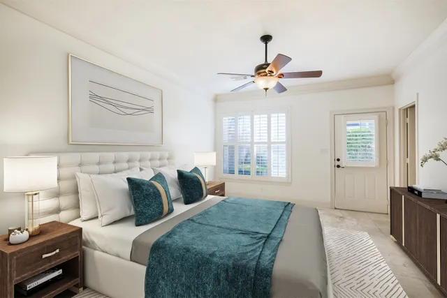 an empty room with chandelier fan and windows