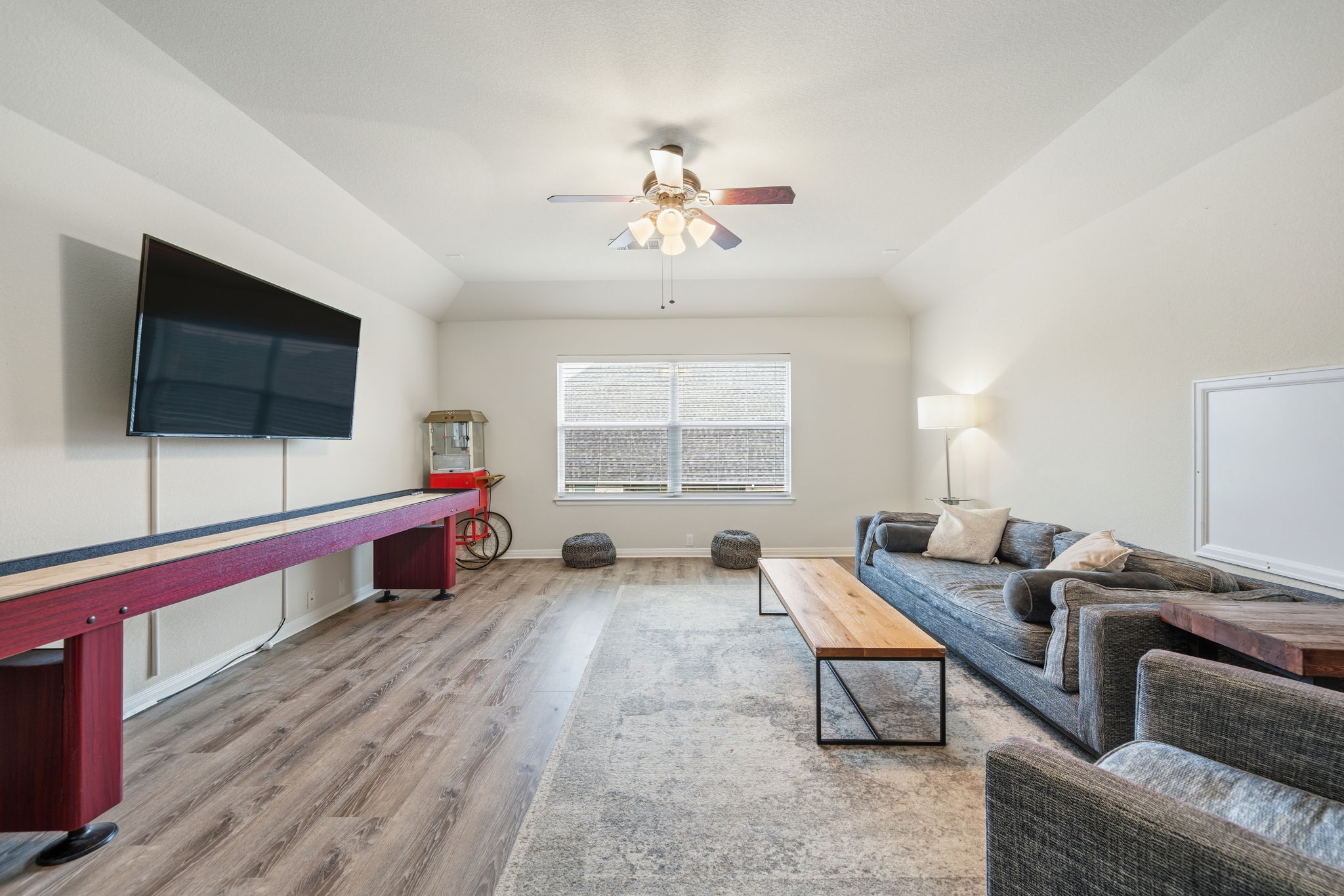 1581 Grassy Field Road Austin, TX 78737 - Photo 26 of 37 Generous ceiling heights and durable wood-look flooring enhance this versatile recreation space.