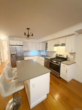 a kitchen with stainless steel appliances granite countertop a sink and a stove